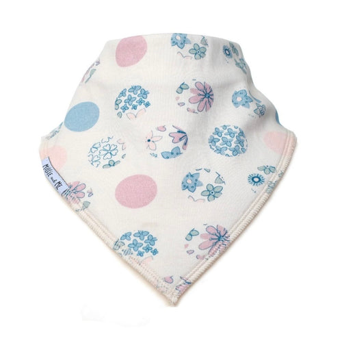 A triangular baby bandana bib in off-white cotton, featuring a pattern of light blue and pink polka dots, flowers, and butterflies. The brand name 'Millie and Me' is printed on the side edge.