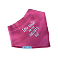 A dusty rose pink baby bib or bandana bib made of soft cotton terry cloth, featuring the phrase 'too cute FOR THE NAUGHTY list' in white script. A small white fabric tag at the bottom edge displays the brand 'Millie and Me'.