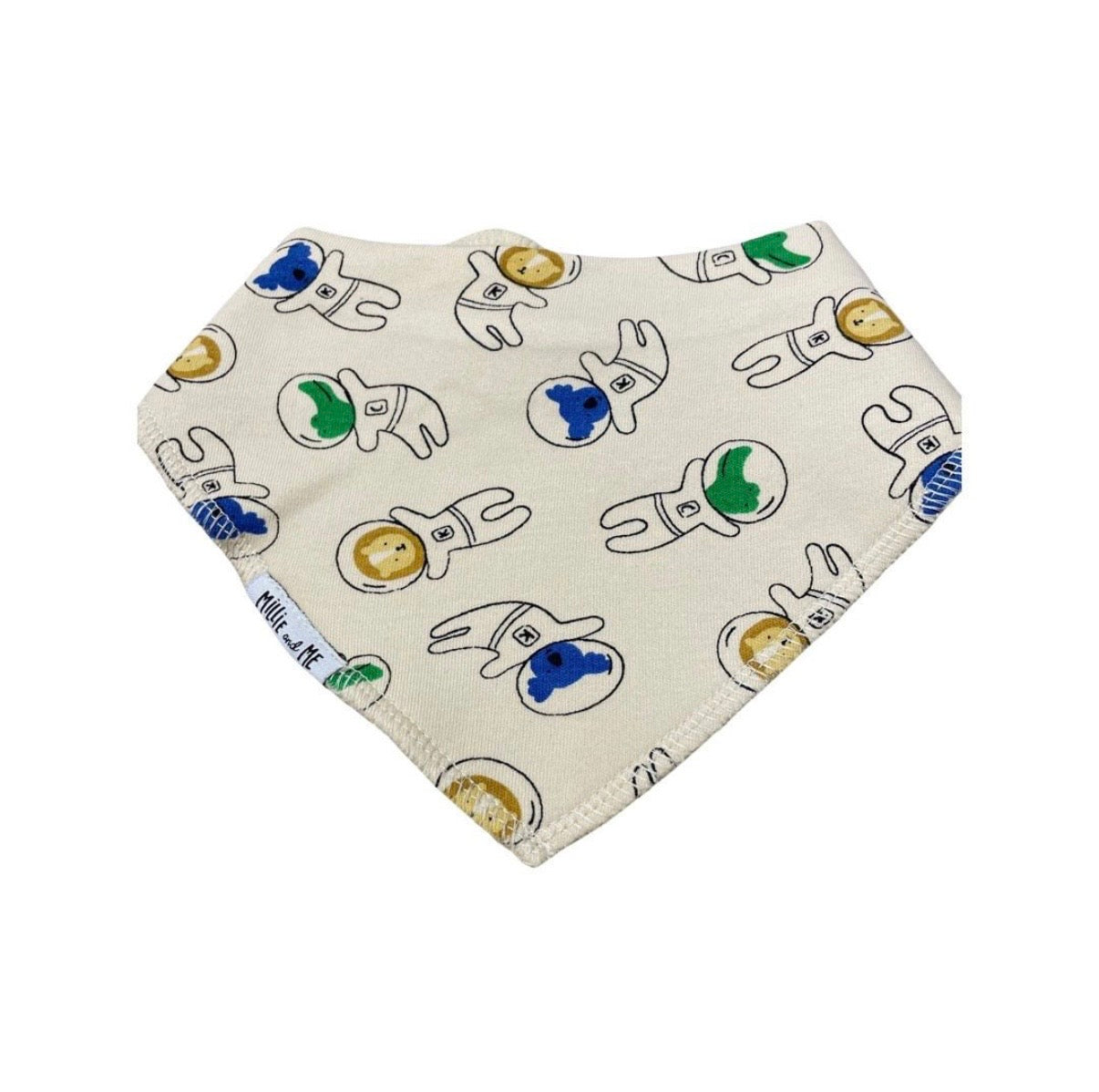 A triangular baby bib with an off-white background, featuring a repeating pattern of cartoon astronauts in white suits with blue and green helmets. The brand name 'Millie and Me' is visible on a small fabric tag near the bottom left edge.