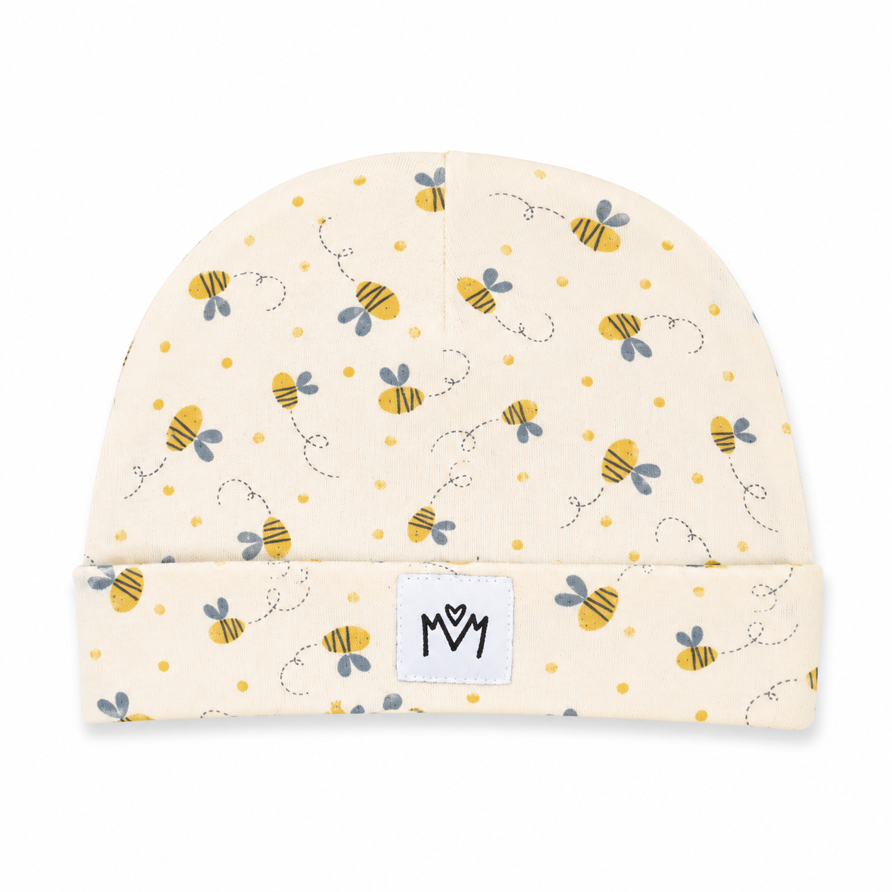 A cream-colored baby beanie hat featuring a playful pattern of yellow and black bumblebees, small yellow dots, and dotted whimsical lines. The hat has a folded cuff with a white square patch displaying the black stylized 'MM' logo.