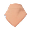 A peach-colored cotton bandana bib or neck gaiter with a small white brand tag on the edge, displayed on a clean white background.
