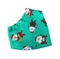 A mint green pet bandana featuring a festive pattern of cartoon Santa Claus and dog characters, with a white fabric tag reading 'Millie and Me' at the bottom.