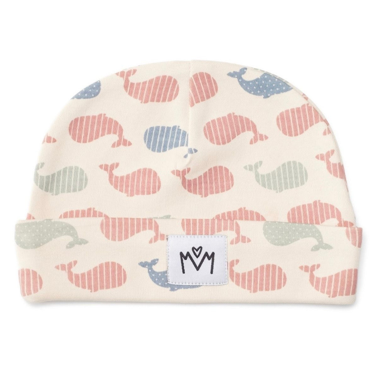 A baby beanie hat featuring a repeating pattern of stylised whales in muted pink, blue, and sage green on an off-white background. It has a folded cuff with a white square patch displaying a black logo.