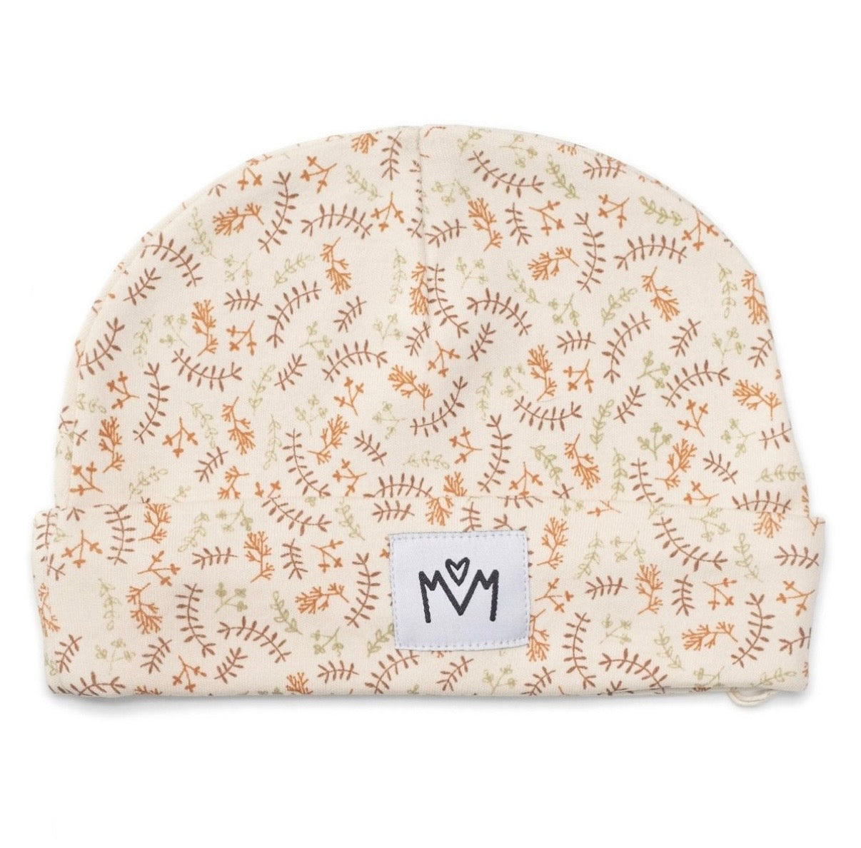 A baby beanie hat featuring a delicate repeating pattern of brown and green botanical line drawings on a warm cream background. A white rectangular brand patch with a black stylised logo is sewn onto the front cuff.