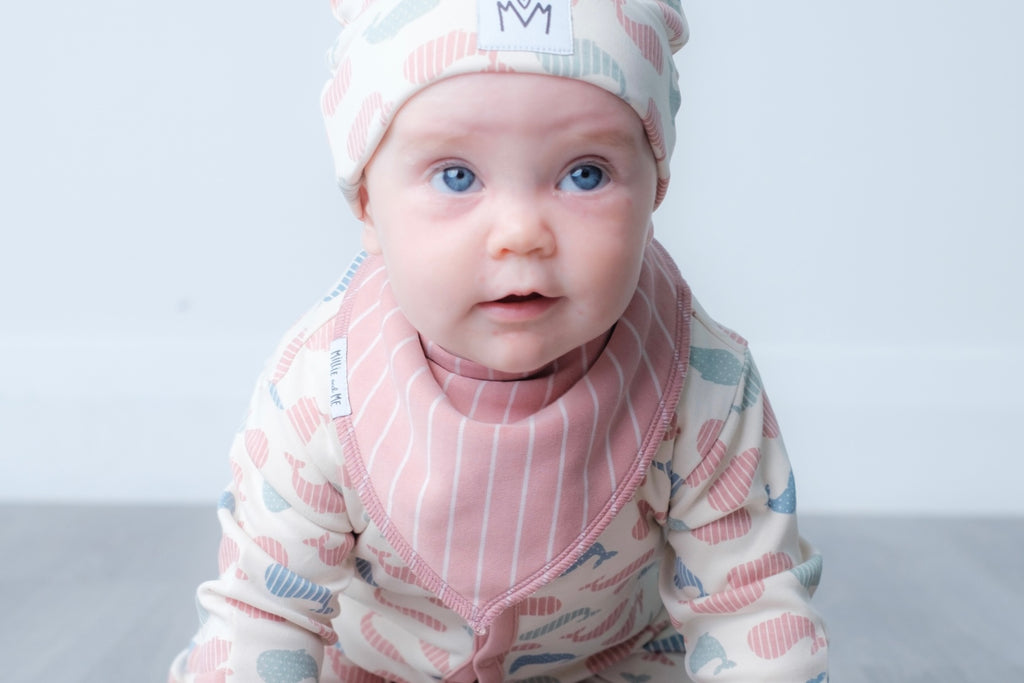 Pink bandana bib with vertical stripe design.