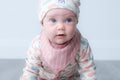 Pink bandana bib with vertical stripe design.