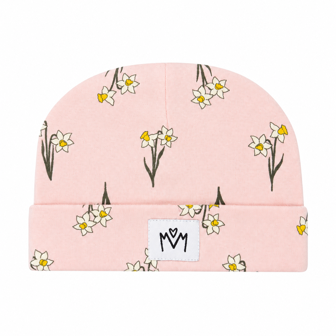 A light pink knit beanie hat featuring a repeating pattern of white daffodils with yellow centers and dark stems, with a white rectangular patch on the front displaying a black stylized 'MM' logo.