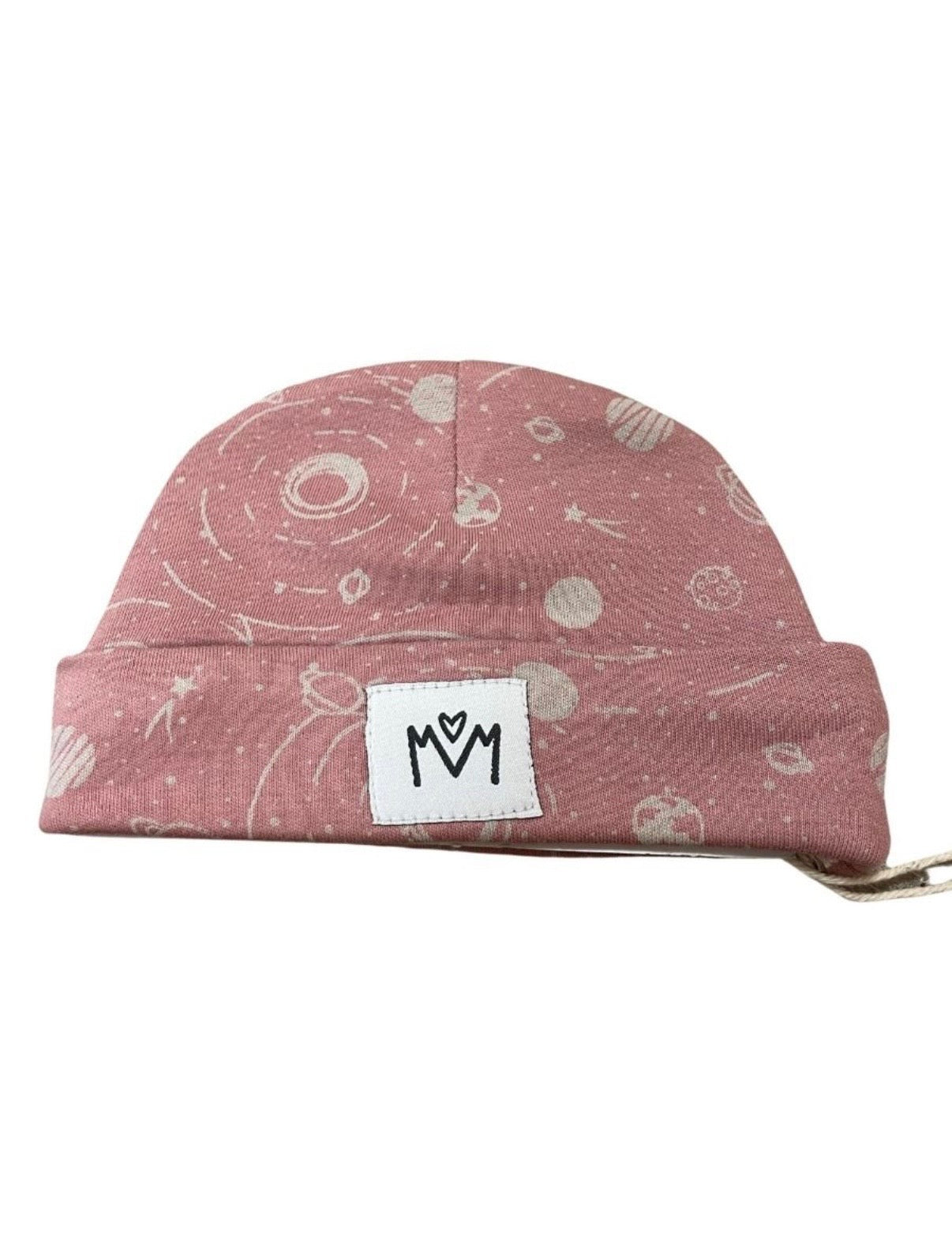 A dusty rose pink beanie with a white space-themed print of planets, stars, and galaxies, featuring a white rectangular patch with a black logo on the front.