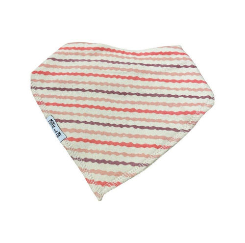 A triangular baby bandana bib with horizontal wavy stripes in dusty pink, terracotta red, and muted purple on an off-white background, featuring a small white brand tag on the side.