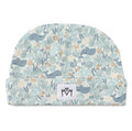 A baby beanie hat featuring a playful underwater pattern with whales, octopus, sea plants, and small fish in muted blue, gray, and beige tones. A small white fabric brand patch with a black logo is sewn onto the front cuff.