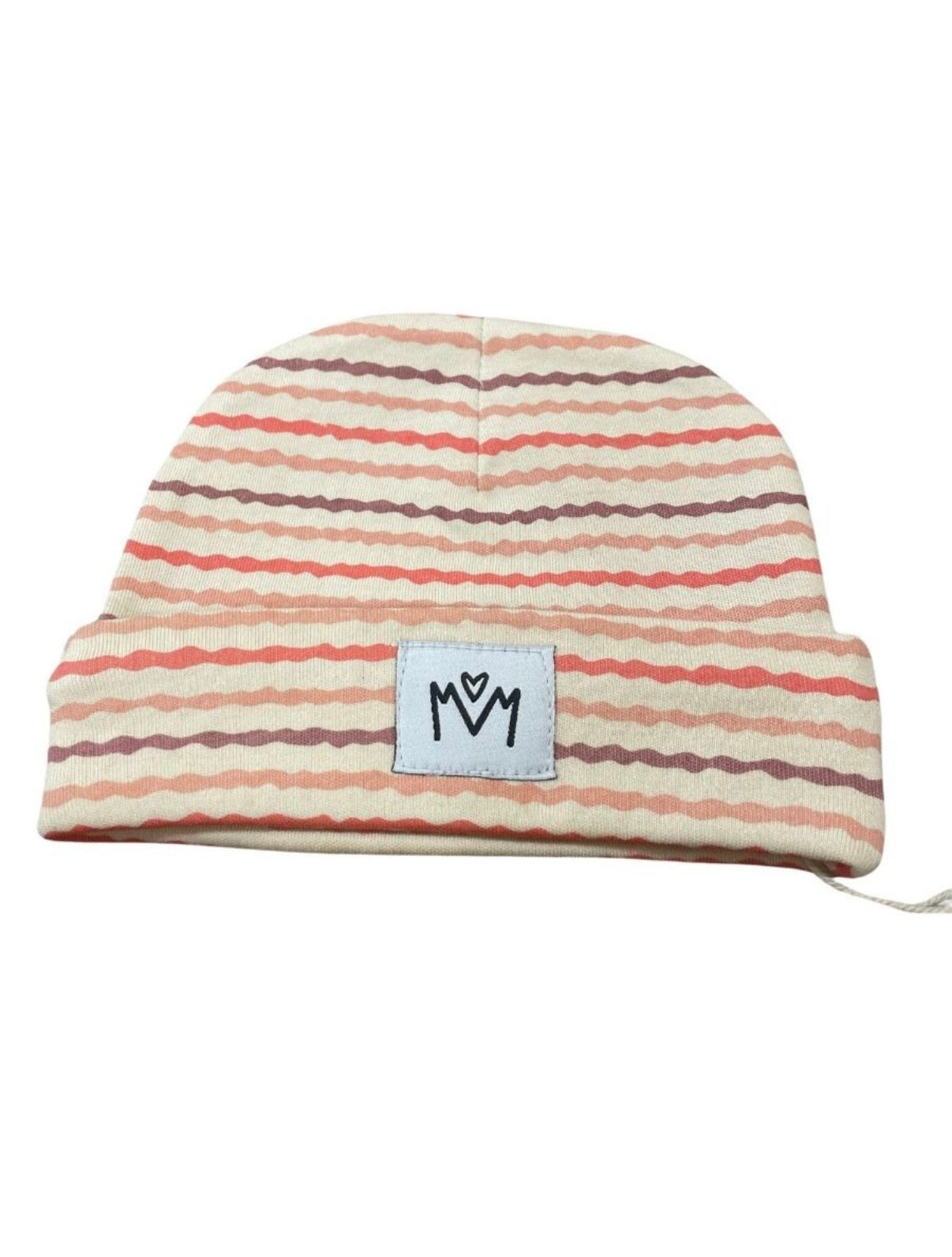 A dusty pink knit beanie hat with a folded cuff, featuring a small white square patch on the front with a black embroidered logo.
