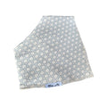 A square baby blanket or swaddle with a light blue and white geometric hexagon pattern, featuring fringed edges and a small white brand label reading 'Millie and Me' at the bottom.