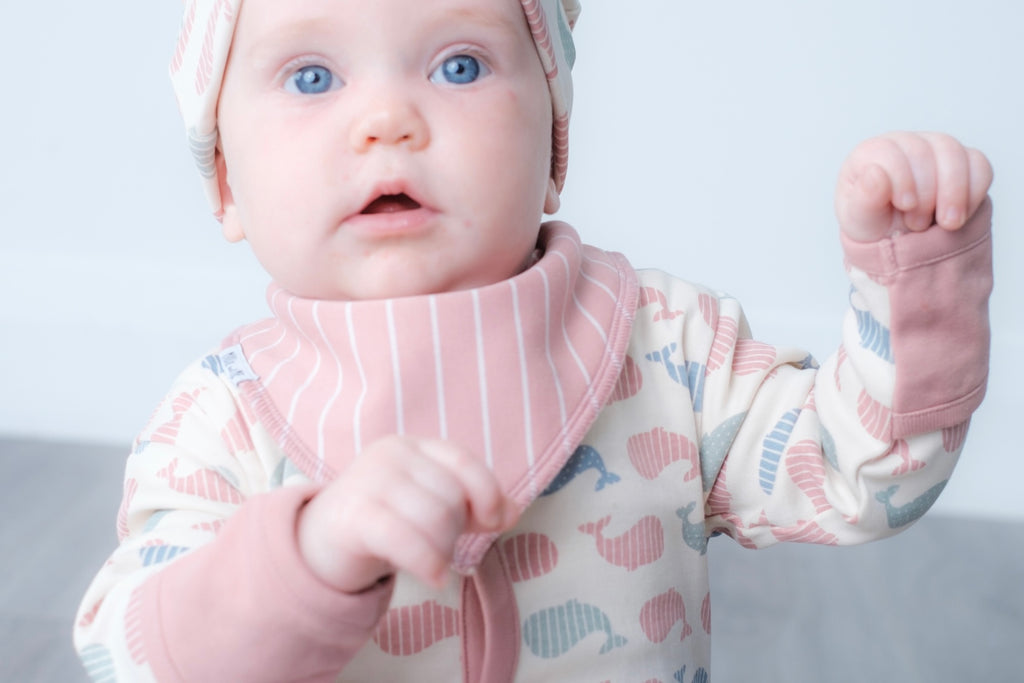 Pink bandana bib with vertical stripe design.