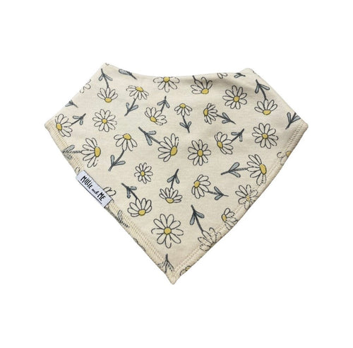 A triangular baby bandana bib with a daisy and leaf pattern on a cream background, featuring a visible 'Millie and Me' brand tag.