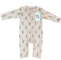 A baby long-sleeve footless one-piece romper in a pale blush pink, featuring an all-over print of small white flowers with green stems. The garment is laid flat on a white background and has a white paper brand tag that reads 'Millie and Me'.