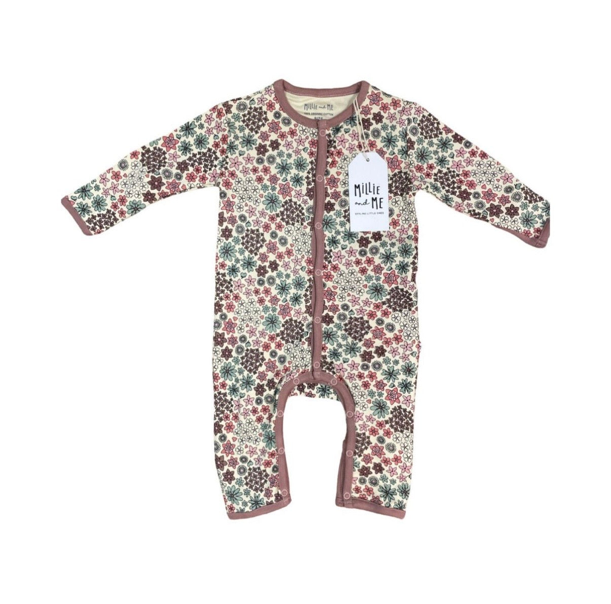 A baby long-sleeve footless one-piece sleeper with a dense floral and geometric pattern in muted pink, green, and brown on a cream background, featuring a white hangtag with the brand name 'Millie and Me'.