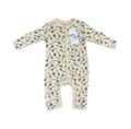 A baby long-sleeve footless one-piece romper in cream with a colourful all-over print of birds, leaves, and dots, featuring a white paper brand tag that reads 'Millie and Me'.