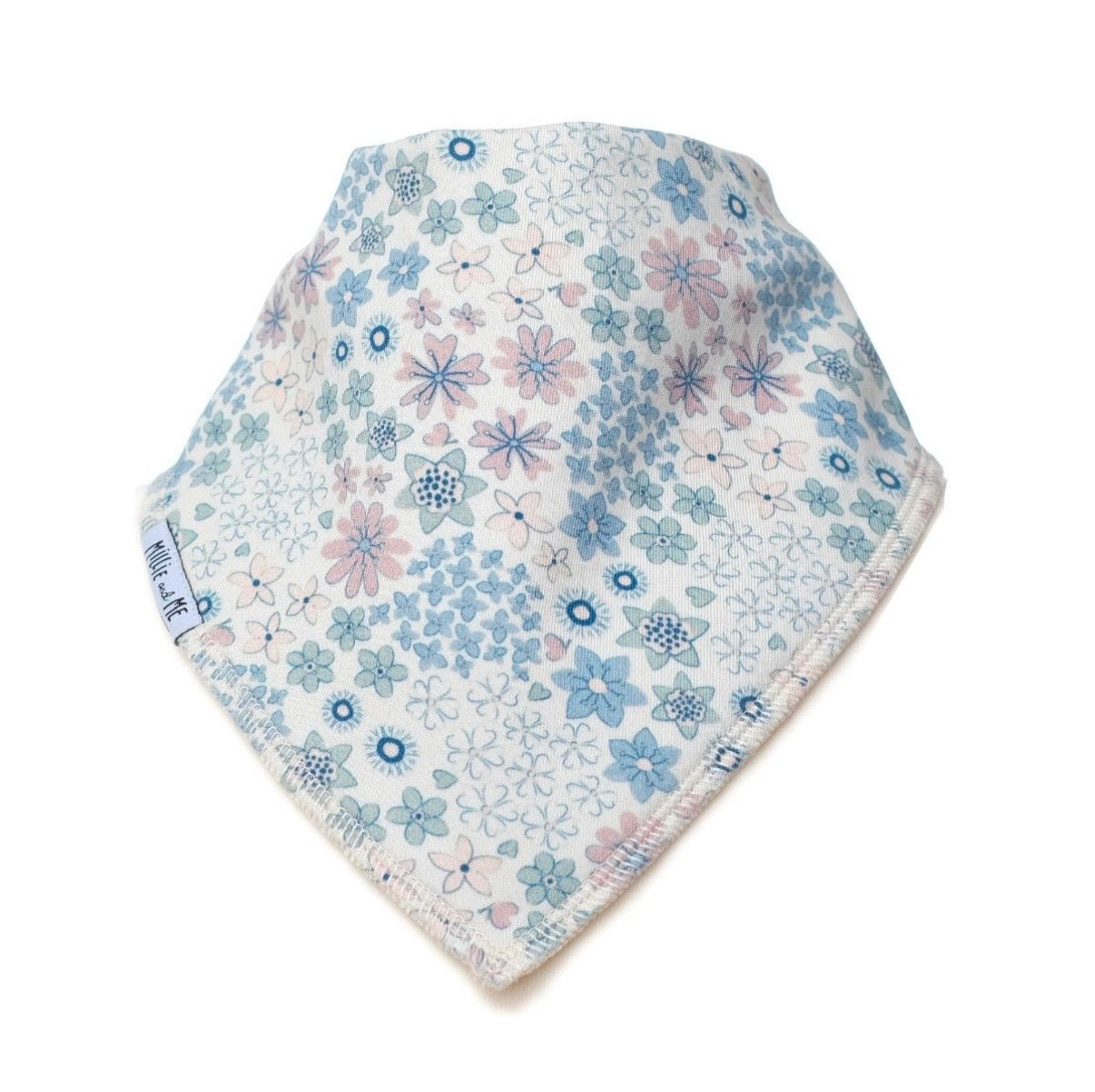 A triangular baby bib with a delicate floral pattern in shades of blue, lavender, and pink on a white background, featuring a small side tag.