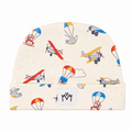 An off-white knit baby beanie hat featuring a playful pattern of colorful toy airplanes and hot air balloons, with a white brand patch on the folded cuff.