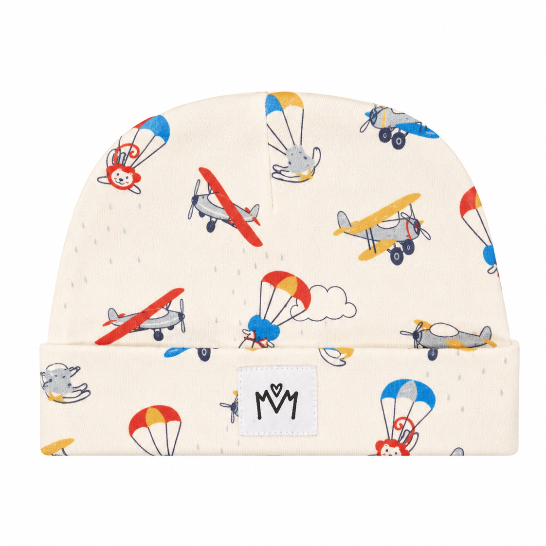 An off-white knit baby beanie hat featuring a playful pattern of colorful toy airplanes and hot air balloons, with a white brand patch on the folded cuff.