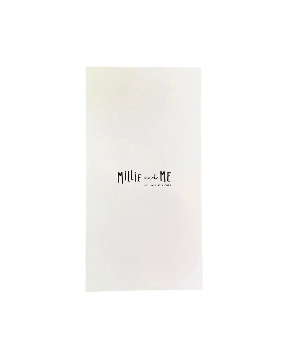 A minimalist white rectangular card or book cover with the text 'Mille and Me' in a black handwritten font and smaller text below reading 'Styling Little Ones', shown on a solid white background.