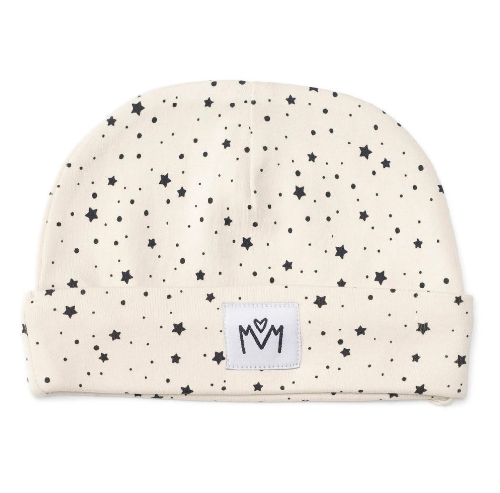 A star patterned beanie hat with a folded cuff, featuring a small white square patch on the front with a black embroidered logo.