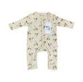 A baby long-sleeve footless one-piece romper in cream with a black and yellow cartoon rabbit print, featuring a white hangtag that reads 'Millie and Me'.
