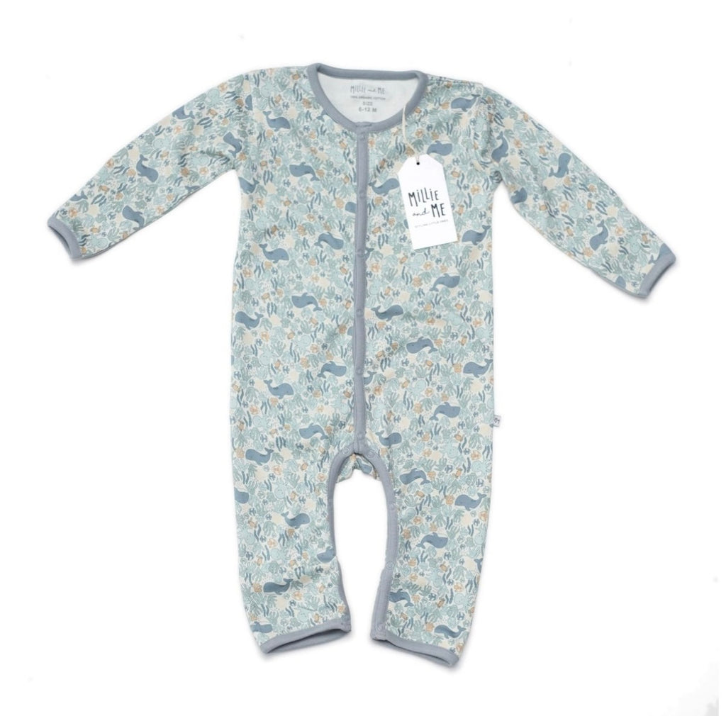 A baby long-sleeve footless one-piece sleeper with an allover woodland animal print in shades of blue, grey, and beige. The garment features a grey trim and ribbed cuffs and hem, with a white 'Millie and Me' brand tag attached.