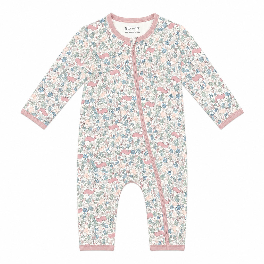 A baby long-sleeve one-piece romper with a pink, blue, and white floral and whale print, featuring a pink zipper and trim, shown on a plain white background.