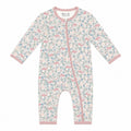 A baby long-sleeve one-piece romper with a pink, blue, and white floral and whale print, featuring a pink zipper and trim, shown on a plain white background.