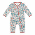 A baby long-sleeve footless one-piece sleeper with an all-over woodland print of foxes and leaves in teal and dusty pink on a cream background, featuring a dusty rose zipper and trim.