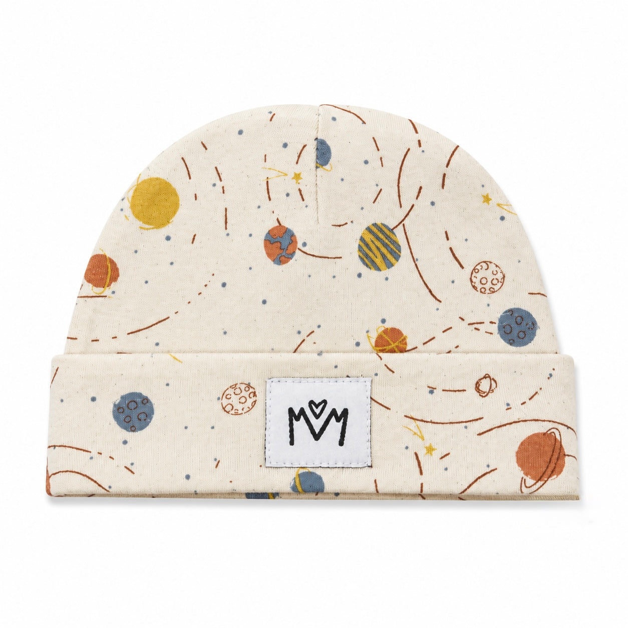 A folded knit beanie in a warm cream color, decorated with a colorful space-themed print of planets, stars, and orbit lines. It features a white square patch on the front folded cuff with a black stylized 'M' logo.