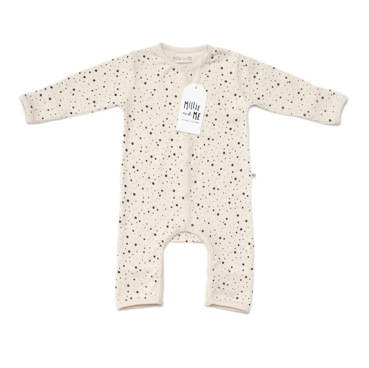 A long-sleeve baby romper in cream with a black speckled pattern, featuring a white hangtag with the brand name 'Millie and Me' and snap closures down the front.