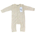 A baby long-sleeve footless one-piece sleeper in cream with a small multicolour polka dot pattern, featuring a white paper brand tag that reads 'Millie and Me'.