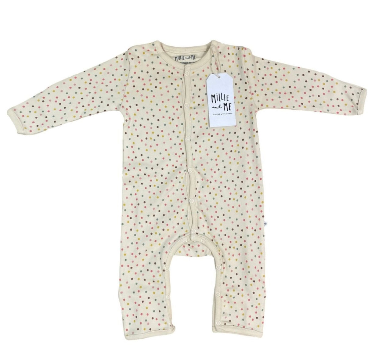 A baby long-sleeve footless one-piece sleeper in cream with a small multicolour polka dot pattern, featuring a white paper brand tag that reads 'Millie and Me'.