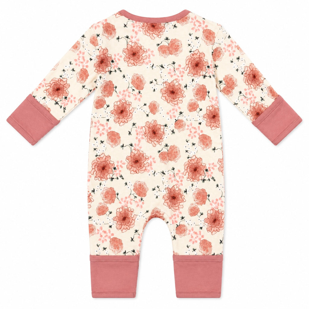 A baby long-sleeve footless one-piece jumpsuit with a cream background, a dusty rose and terracotta floral pattern, and solid dusty rose cuffs and leg cuffs, shown flat on a white background.