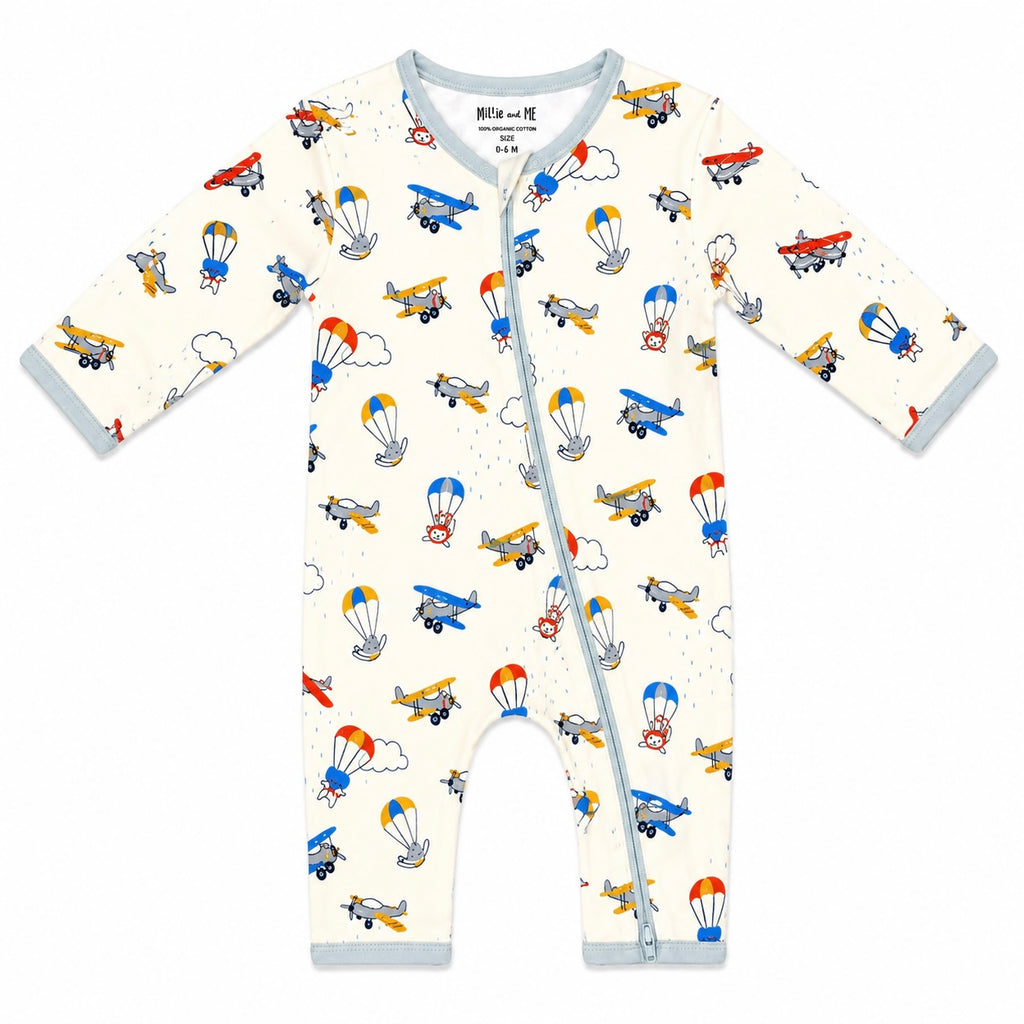 A baby long-sleeve footless one-piece sleeper with a light blue zipper and trim, featuring an all-over retro airplane and hot air balloon pattern on a cream background.