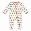A long-sleeve baby footless one-piece sleeper with an off-white base, decorated with a pattern of polka dots and floral circles in muted blue, pink, green, and brown tones. It features a dusty rose trim along the collar, zipper placket, cuffs, and ankles.