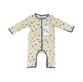 A baby long-sleeve footless sleep sack with an off-white background, decorated with a colorful pattern of small circles and swirls, finished with slate blue trim and featuring a white paper tag.