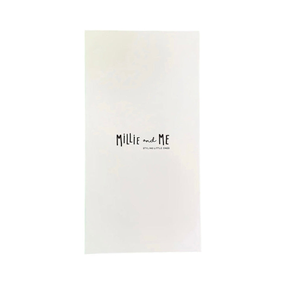 A minimalist white rectangular card or book cover with the text 'MILLIE and ME' in a black handwritten font and smaller text below reading 'Styling Little Ones', shown on a solid white background.