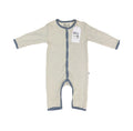 A baby long-sleeve footless sleeper with a beige and white geometric pattern and slate blue trim, featuring a white hangtag with 'Millie and Me' branding.