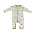 A baby long-sleeve footless romper in cream with a colourful abstract pattern of circles and swirls, finished with tan trim and a white hangtag.