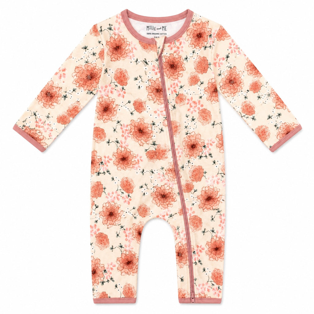 A long-sleeve baby footless one-piece romper with a floral print on a cream background, featuring dusty pink trim and a pink zipper closure.