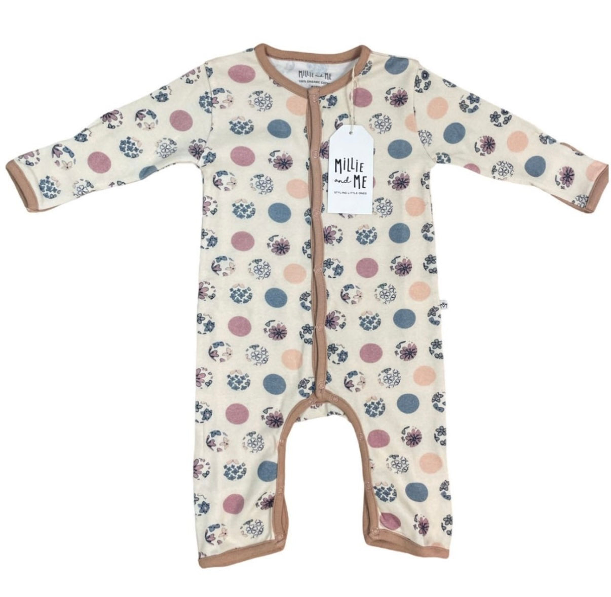 A long-sleeve baby footless one-piece sleeper with an all-over polka dot pattern in dusty pink, slate blue, and black on a cream background. It features tan trim and a white hangtag with the brand name 'Millie and Me'.