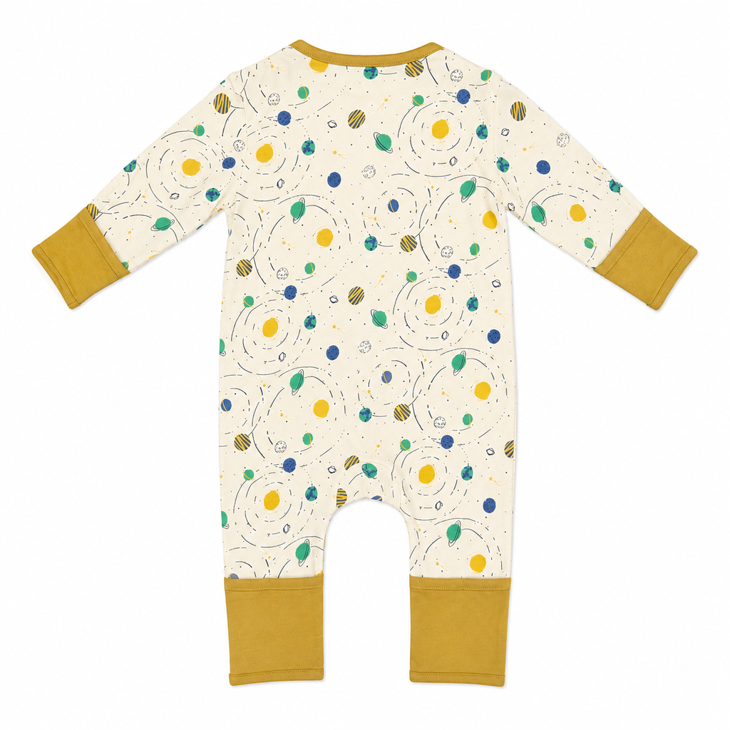 A baby long-sleeve footless one-piece romper shown flat on a white background. The romper has a cream-colored body with a colorful abstract pattern of yellow, blue, and green dots and swirls, with mustard yellow cuffs on the sleeves and legs.