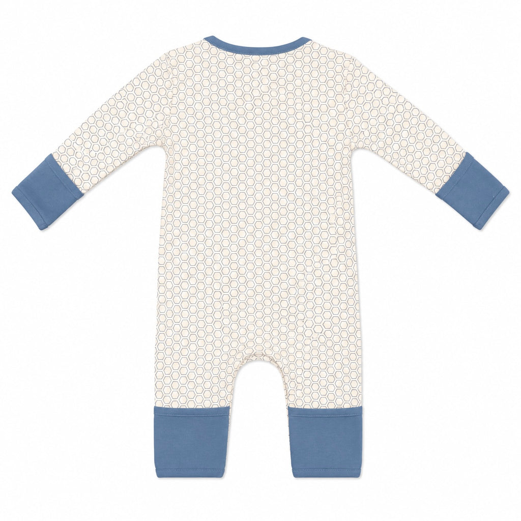 A baby long-sleeve footless romper with a cream and white geometric pattern, featuring solid blue cuffs and leg hems, shown flat on a white background.