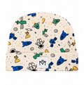 A folded beanie hat with a cream-colored background and an all-over cartoon space-themed print featuring blue rockets, green planets, white astronauts, and black stars. A white square brand patch with the letters 'MM' is stitched on the front cuff.
