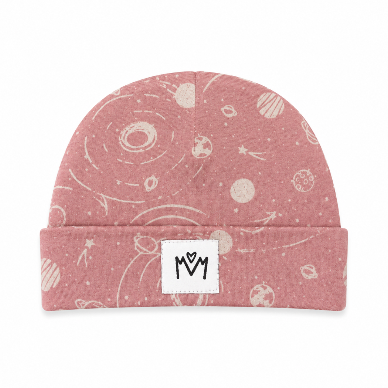 A dusty pink beanie with a white space-themed print of planets, stars, and orbits, featuring a white fabric patch on the folded cuff with a black stylized 'M' logo.