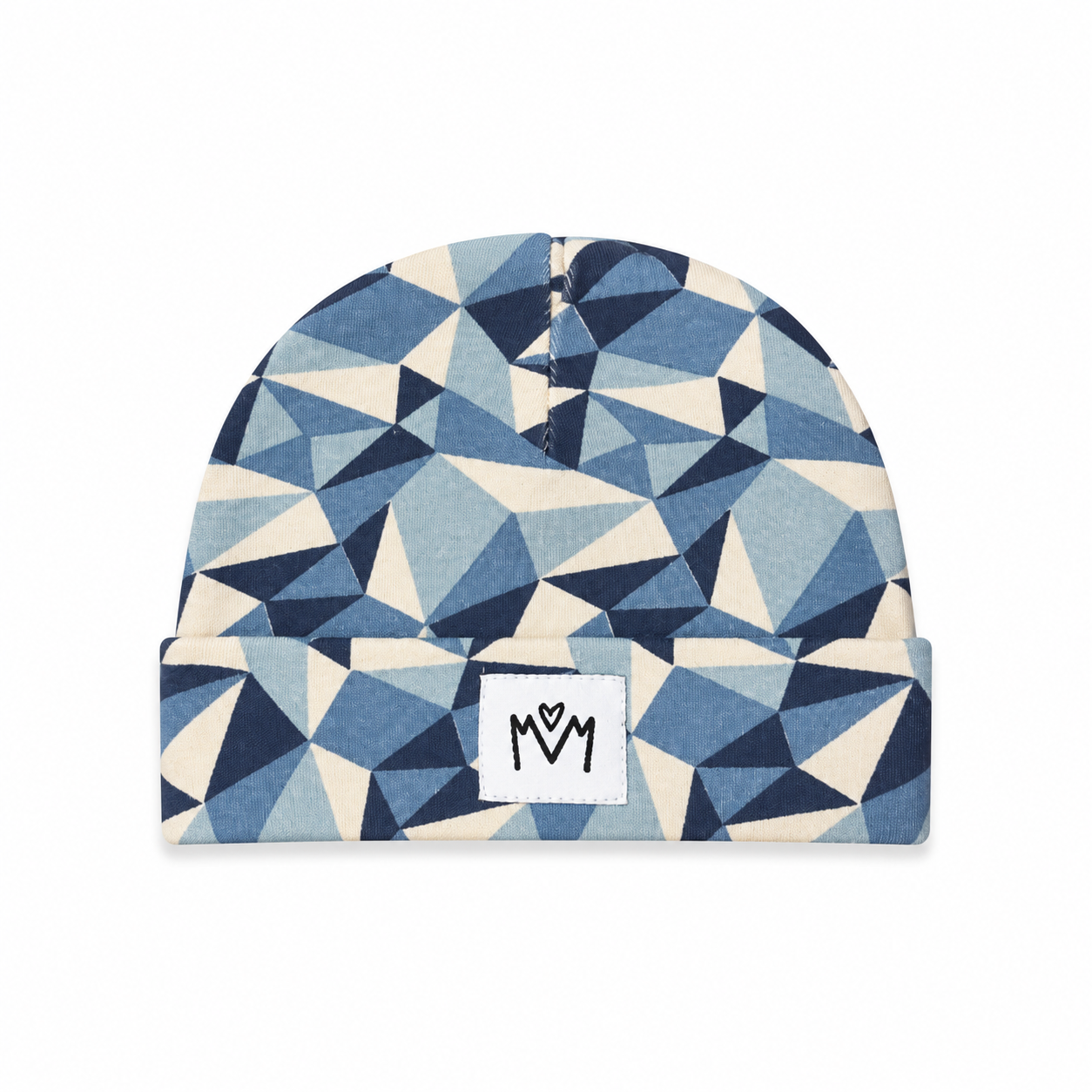 A folded beanie hat with a geometric triangle pattern in navy, light blue, and cream, featuring a white rectangular patch on the front with a black stylized 'M' logo.