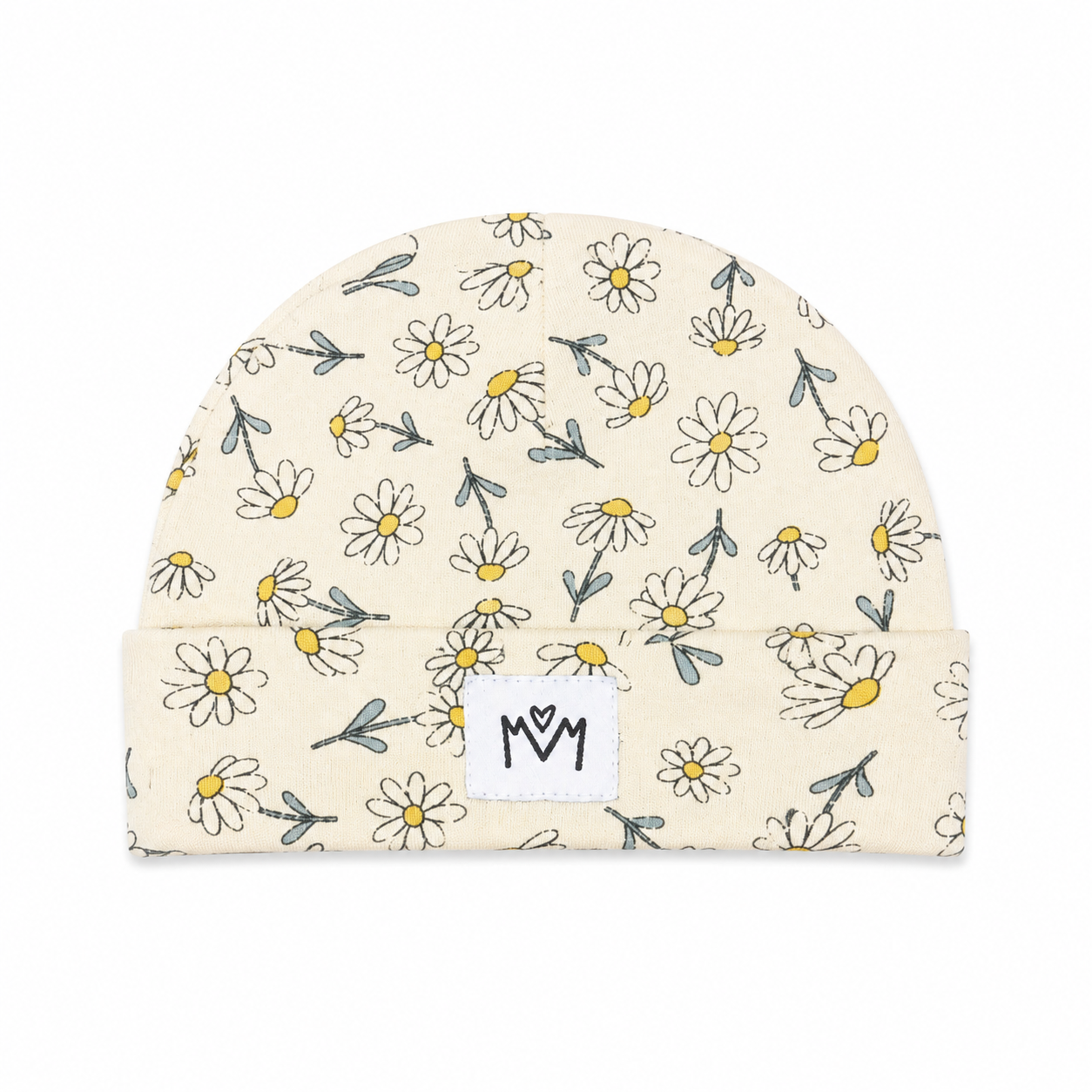 A cream-colored knit beanie hat with a repeating pattern of hand-drawn white daisies with yellow centers and gray-green stems. It features a white fabric patch on the folded cuff with the letters 'MOM' in black.